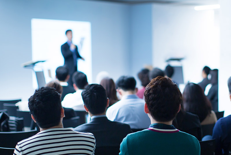 Man performing lecture on stage